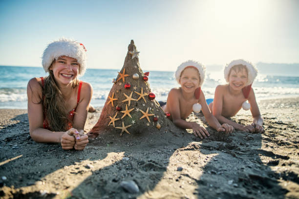 Kids enjoying summer Christmas Three kids are having fun during summer Christmas. Family wearing Santa hats is decorating a sand Christmas tree.
Nikon D850 girls laying on beach stock pictures, royalty-free photos & images