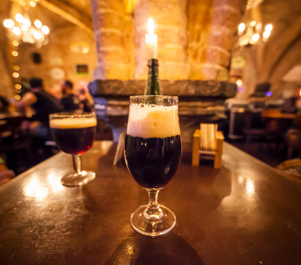 Two glasses of craft beer and a romantic candle in a typical belgian pub