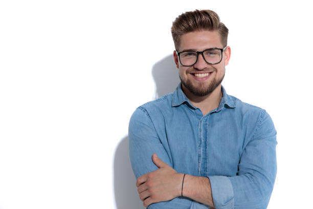 istock confident young casual man standing with hands crossed 1171751429