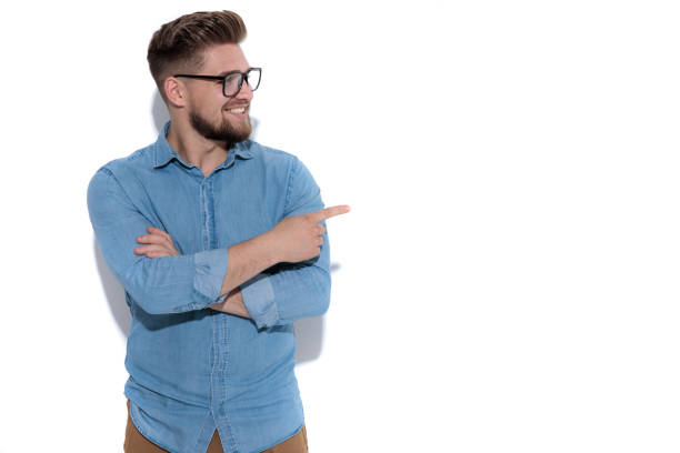 istock happy casual man standing  and points finger to side 1171751465