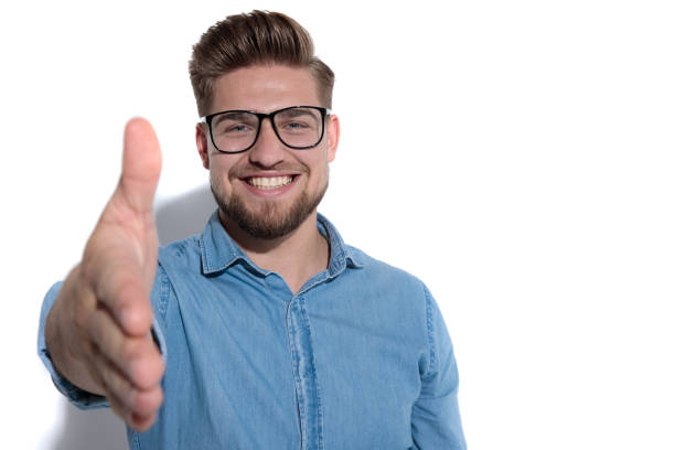 istock smiling young smart casual man greets with a handshake 1171751487