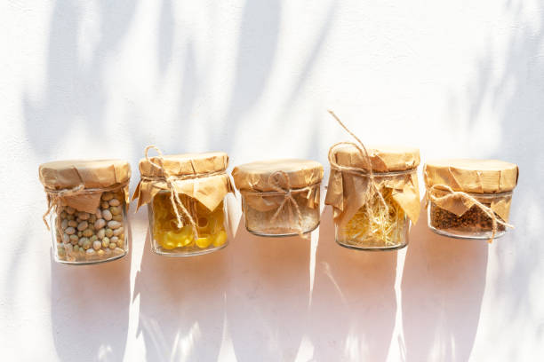 Cereals in glass jars on a light background with a shadow. Eco storage, zero waste