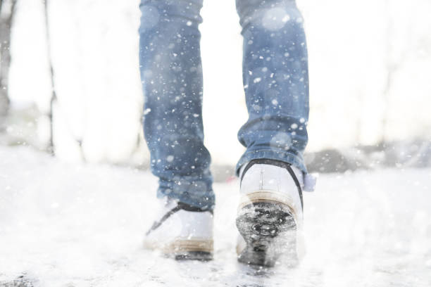 istock A man walks through the city on snowy winter day. 1171752111