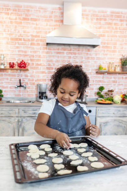 istock Little girl preparing homemade biscuits 1171752977