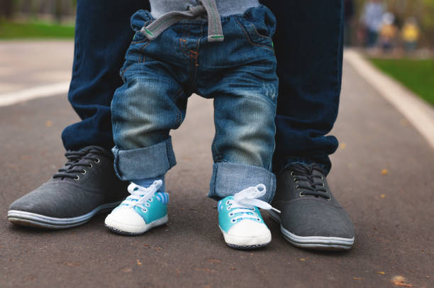 legs of child and adult. - healthy lifestyle nature sports shoe childhood imagens e fotografias de stock