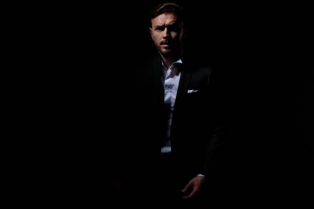 istock charming business man in tuxedo confidently looking at camera 1171754908