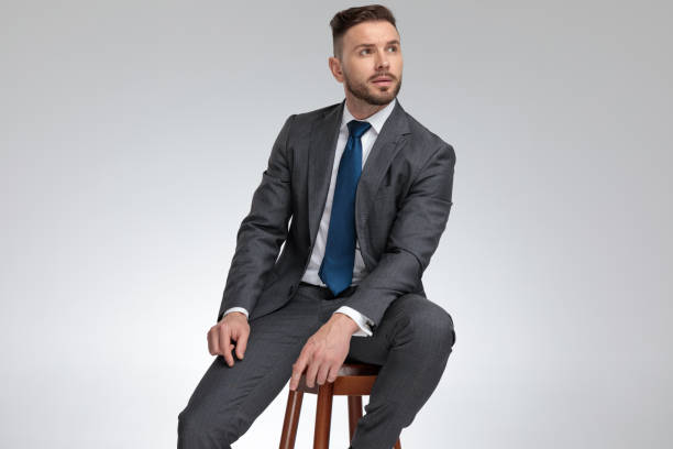 istock young elegant businessman sits on stool and dreams 1171755001