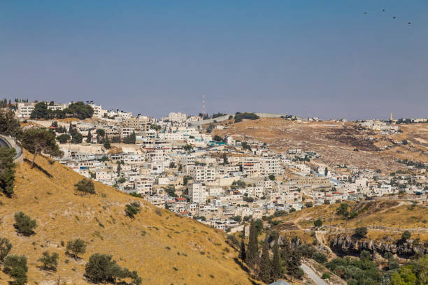 Small village and the Israeli West Bank barrier or wall - separation barrier on the West Bank in Israel. View from Montefiore Windmill Small village and the Israeli West Bank barrier or wall - separation barrier on the West Bank in Israel. View from Montefiore Windmill bethlehem west bank stock pictures, royalty-free photos & images