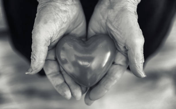 istock elder woman holding heart 1171757183