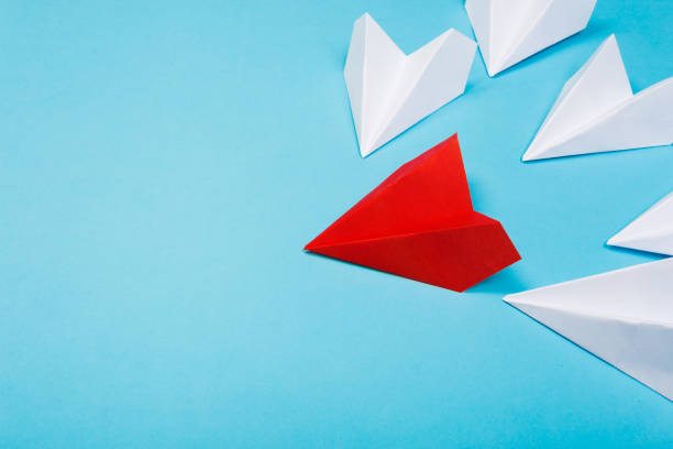 istock Red paper plane are different from others on blue background. Think different. Business for innovative, solution concepts 1171760378