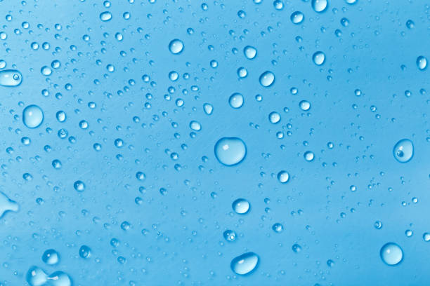 istock Rain droplets on blue glass background, Water drops on blue glass. 1171760577