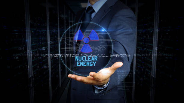 istock Businessman touch screen with nuclear energy symbol hologram 1171762857