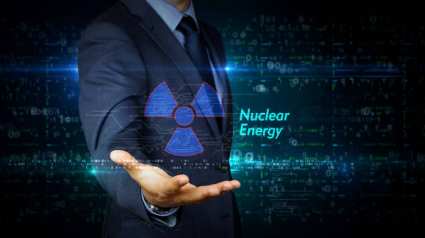 istock Businessman touch screen with nuclear energy symbol hologram 1171762904