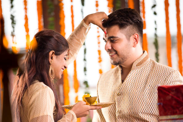 istock Sister applying tilaka to brother on raksha bandhan 1171763581