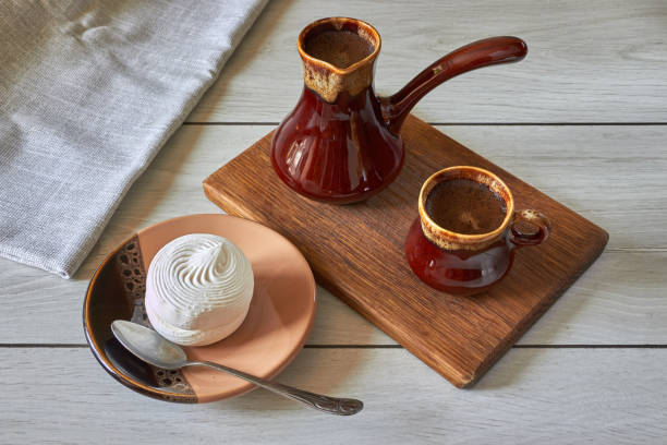 istock cup of coffee with cezve and marshmallow 1171765392