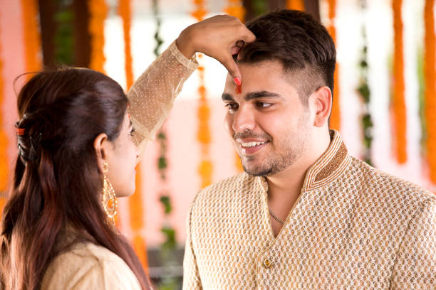 istock Sister applying tilaka to brother on raksha bandhan 1171765409