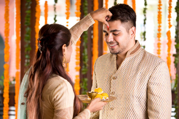 istock Sister applying tilaka to brother on raksha bandhan 1171765488