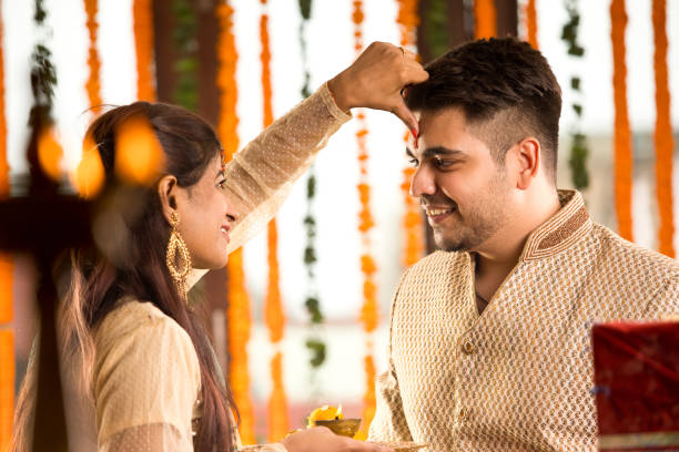 istock Sister applying tilaka to brother on raksha bandhan 1171765552