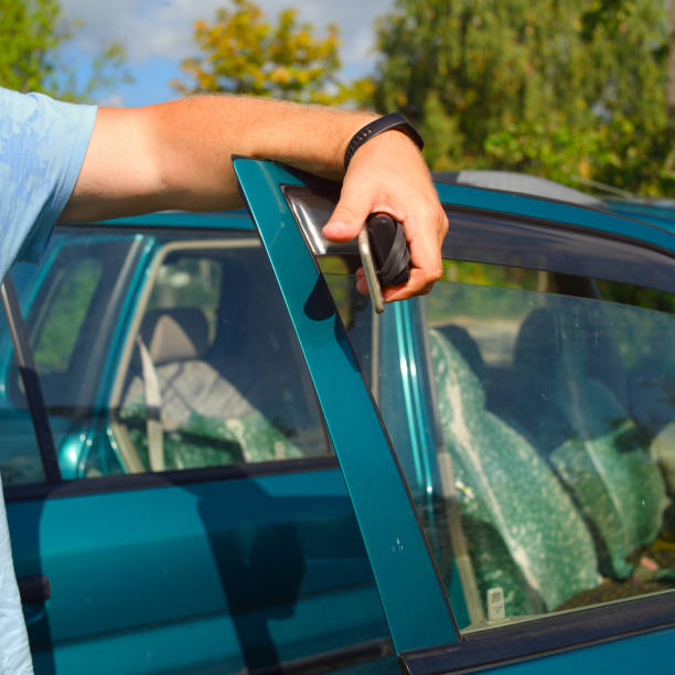 istock man standing near his car with open doors 1171766948