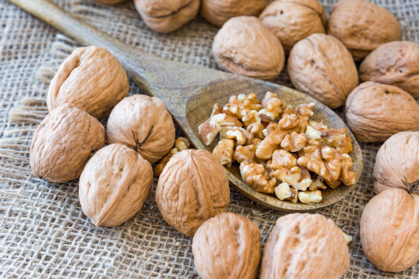 istock On burlap, peeled walnuts peeled on a wooden spoon. 1171771792