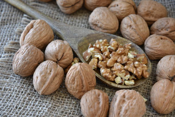 istock On burlap, peeled walnuts peeled on a wooden spoon. 1171773024