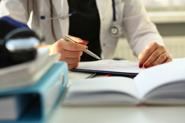 istock Female doctor hand hold silver pen filling 1171773157