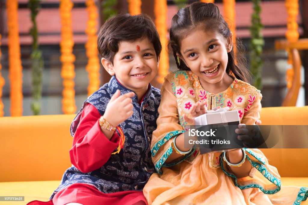 Brother and sister with gift box Loving brother and sister with gift box celebrating traditional Indian festival Rakhi Stock Photo