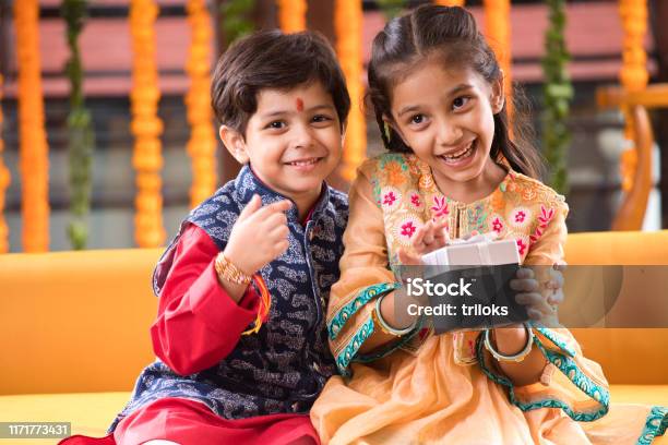 Brother And Sister With Gift Box Stock Photo - Download Image Now - Rakhi, Traditional Festival, Diwali