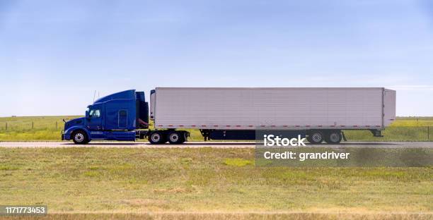 A Cloesup View Of A Long Haul Semi Truck Speeding Down A Four Lane Highway Stock Photo - Download Image Now