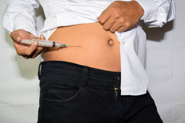 istock Close up Asian man's hand is making an injection isolated on white background 1171775240