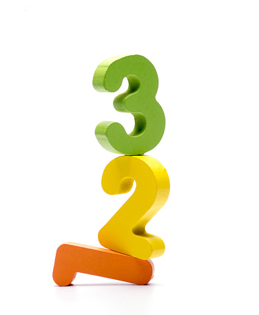 Colourful wooden numeric on top of each other on white background.