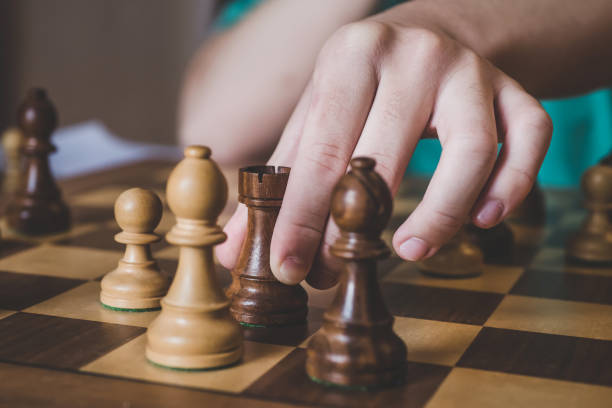 istock Close up of hand paying chess game 1171777979