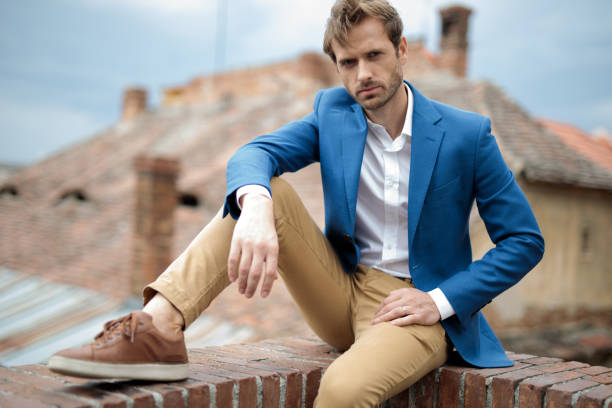 istock serious seated young smart casual man resting elbow on knee 1171778088