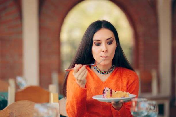 istock Funny Woman Eating Cake in a Restaurant 1171780185