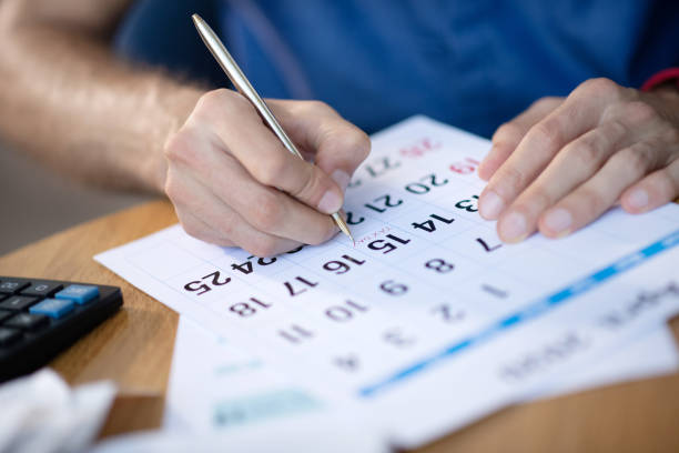istock Businessman near calendar working on schedule 1171780871