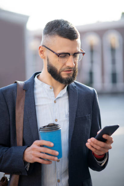 istock Busy businessman drinking coffee and reading messages 1171781013