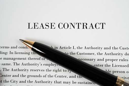 Pen on top of a lease contract ready to be signed