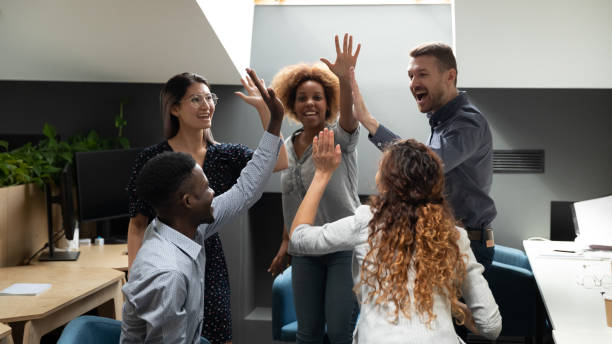 istock Excited euphoric multiracial business team give high five in office 1171786239