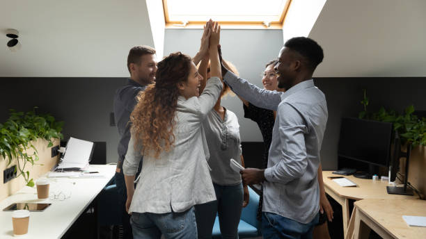 istock Diverse office business team give high five share corporate success 1171786242