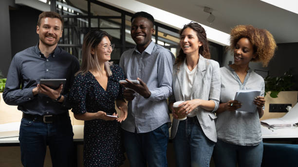 istock Cheerful happy multicultural business team laughing standing in office 1171786251