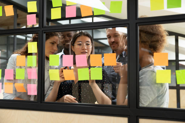 istock Focused multiethnic business team brainstorm with sticky notes in office 1171786299