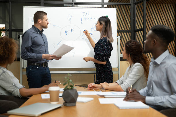 istock Diverse asian and caucasian coaches drawing on whiteboard in office 1171786332