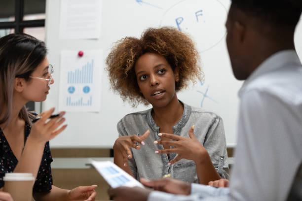 istock Female african female leader talking during group office briefing 1171786333