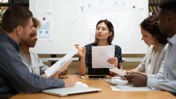 istock Female asian executive discuss paperwork with diverse partners at meeting 1171786337