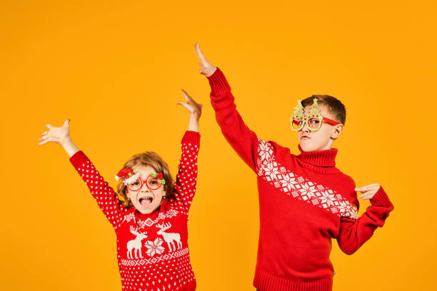 istock Children in warm red Christmas sweaters 1171786515