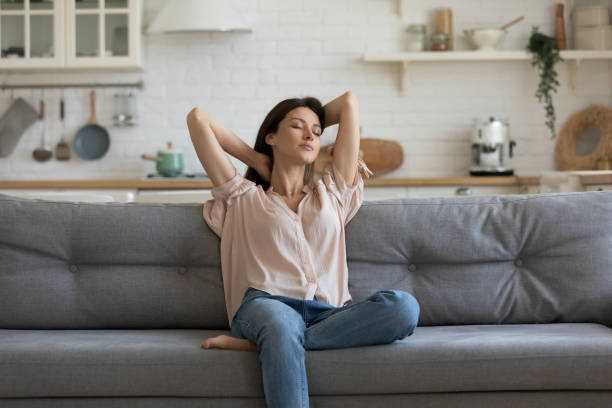 istock Woman enjoy free time resting on couch at home 1171789088