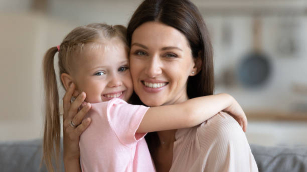 istock Mother and daughter embracing looking at camera feels happy 1171789114