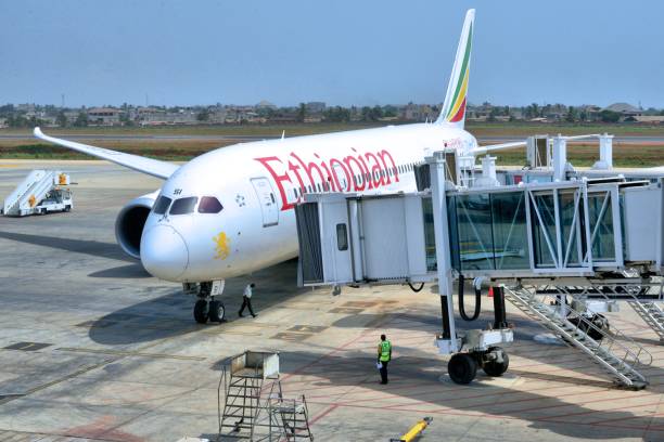 Lomé-Tokoin International Airport - Ethiopian Airlines Boeing 787 Dreamliner, Lomé, Togo Lomé, Togo: Ethiopian Airlines Boeing 787-8 Dreamliner (ET-ASI)-arrives at an airbridge - Lomé–Tokoin International Airport - Gnassingbé Eyadéma International Airport (IATA: LFWICAO: DXXX) london fashion week stock pictures, royalty-free photos & images