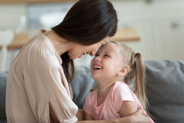 istock Mother daughter touch foreheads laughing enjoy time together 1171789178