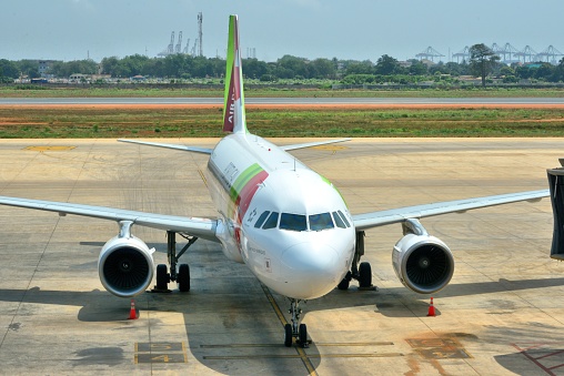 Lomé, Togo:  TAP - Air Portugal Airbus A320-200 (CS-TNS) arrives from Lisbon - Lomé–Tokoin International Airport - Gnassingbé Eyadéma International Airport (IATA: LFWICAO: DXXX) - Lome port cranes in the background.